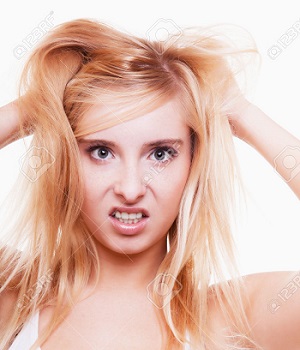 Stress frustration. Young emotional woman teen girl angry frustrated and stressed pulling her hair. Studio shot isolated on white background